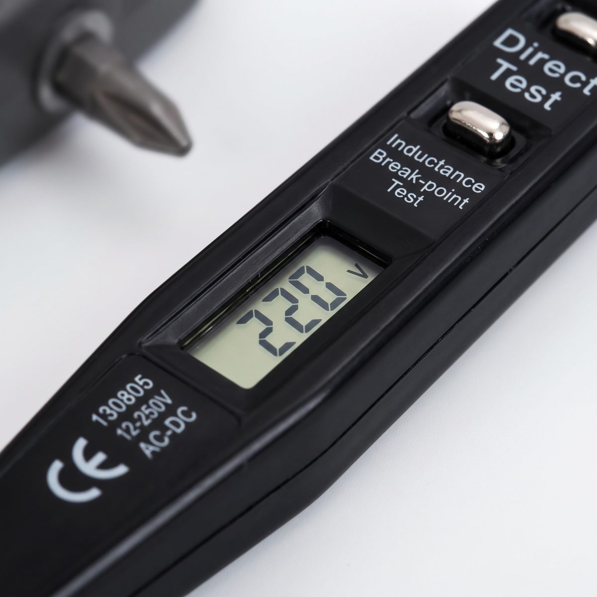 CHINYOO pen voltage tester showing 220 V on its display, with direct test and inductance break-point test buttons beside it